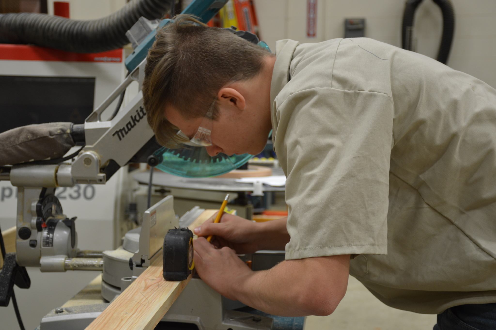 Carpentry Student measuring for cut