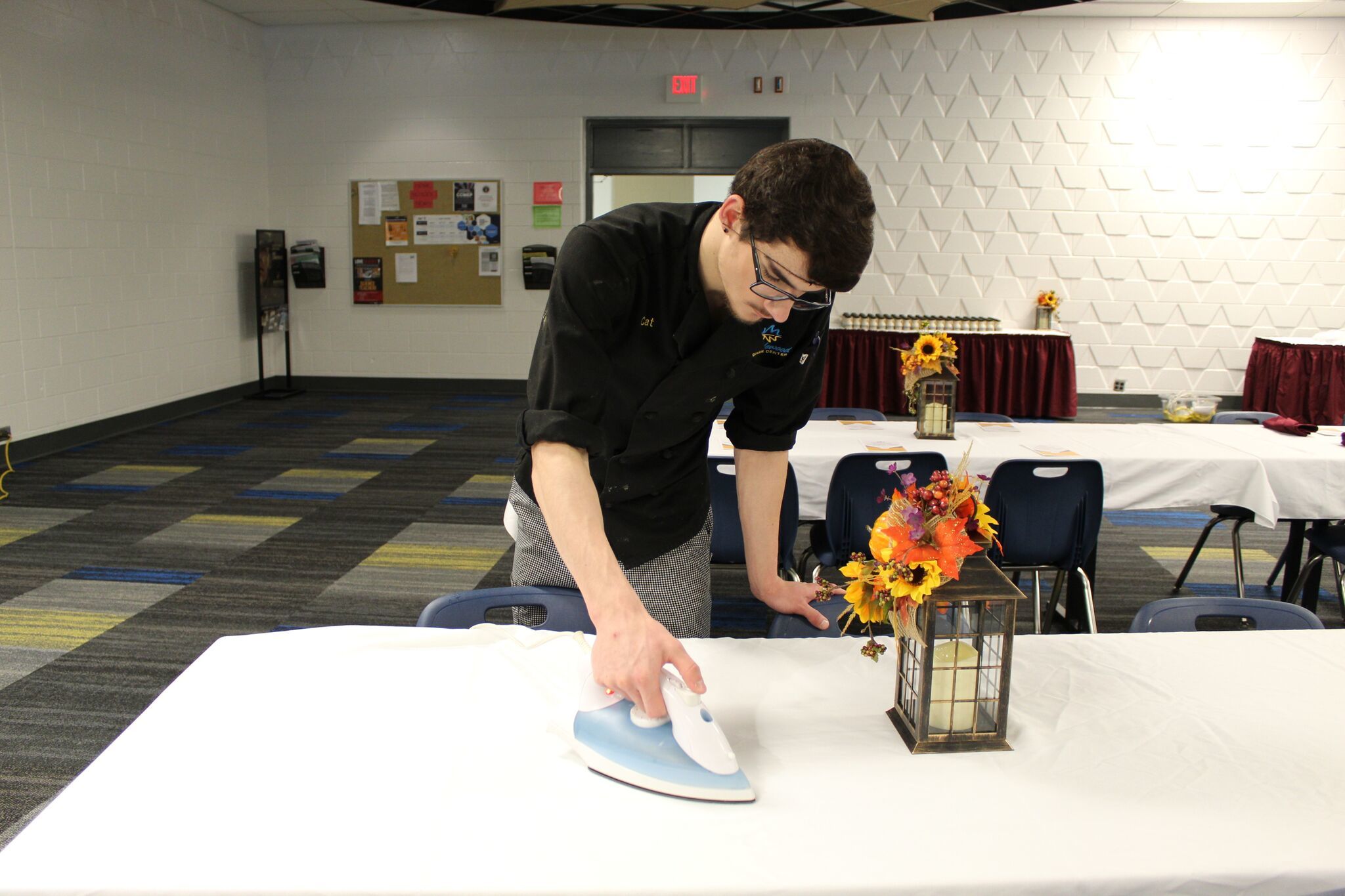 Culinary Arts student ironing tablecloth