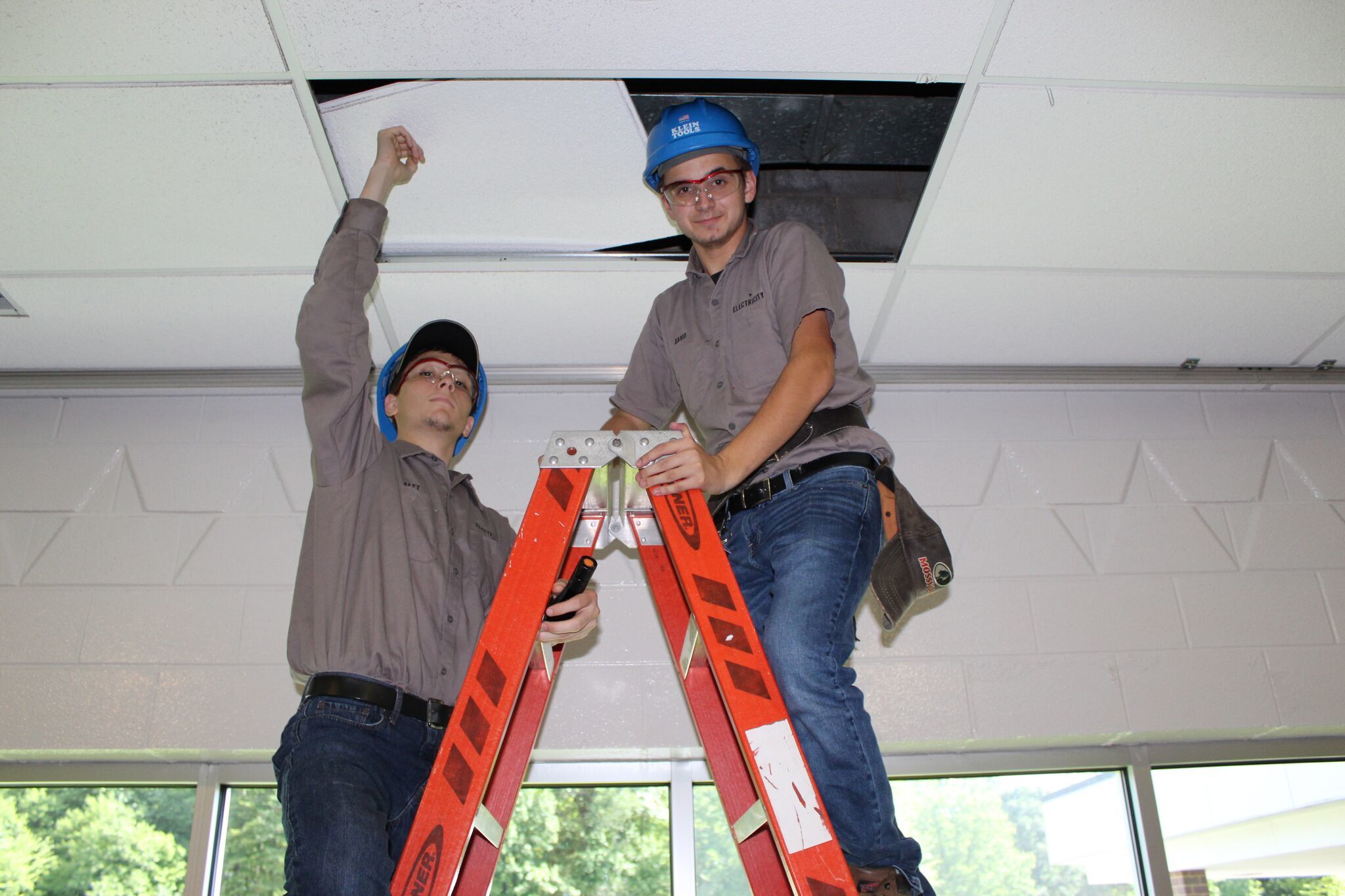 Electricity Students working on lights in cafeteria