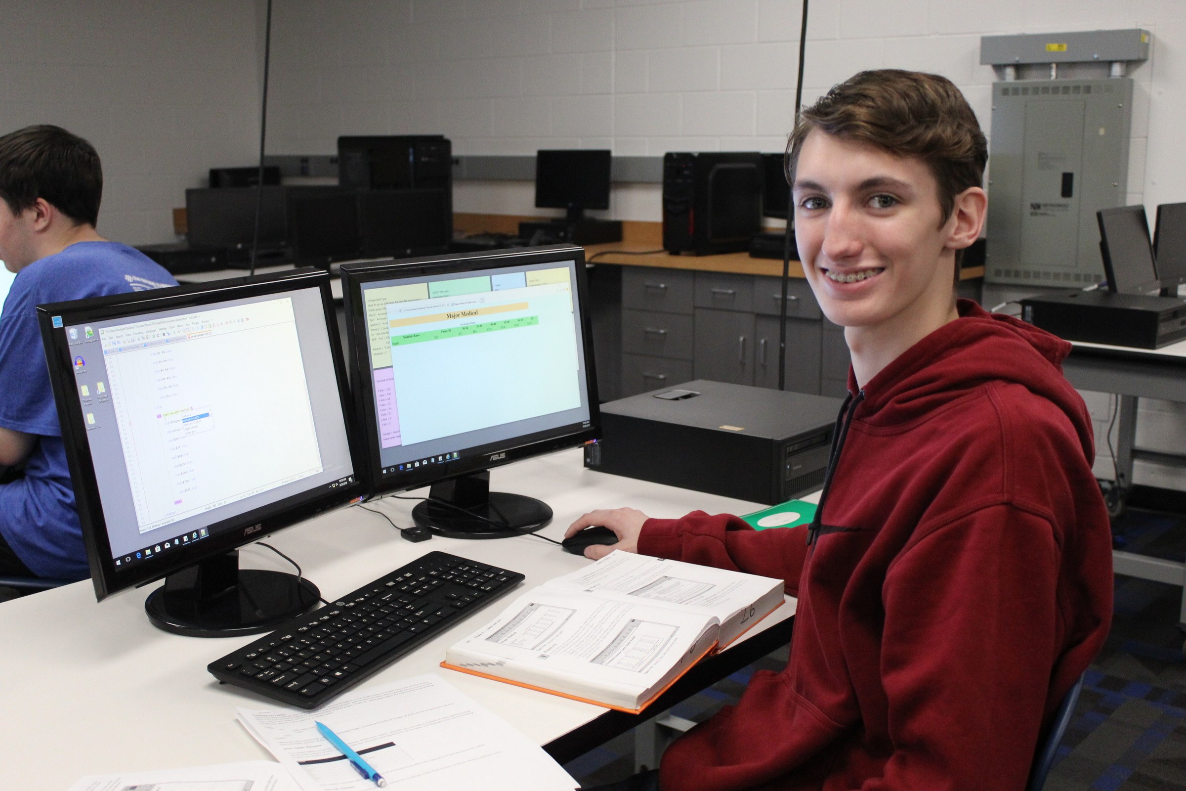 Information Technology student coding in lab