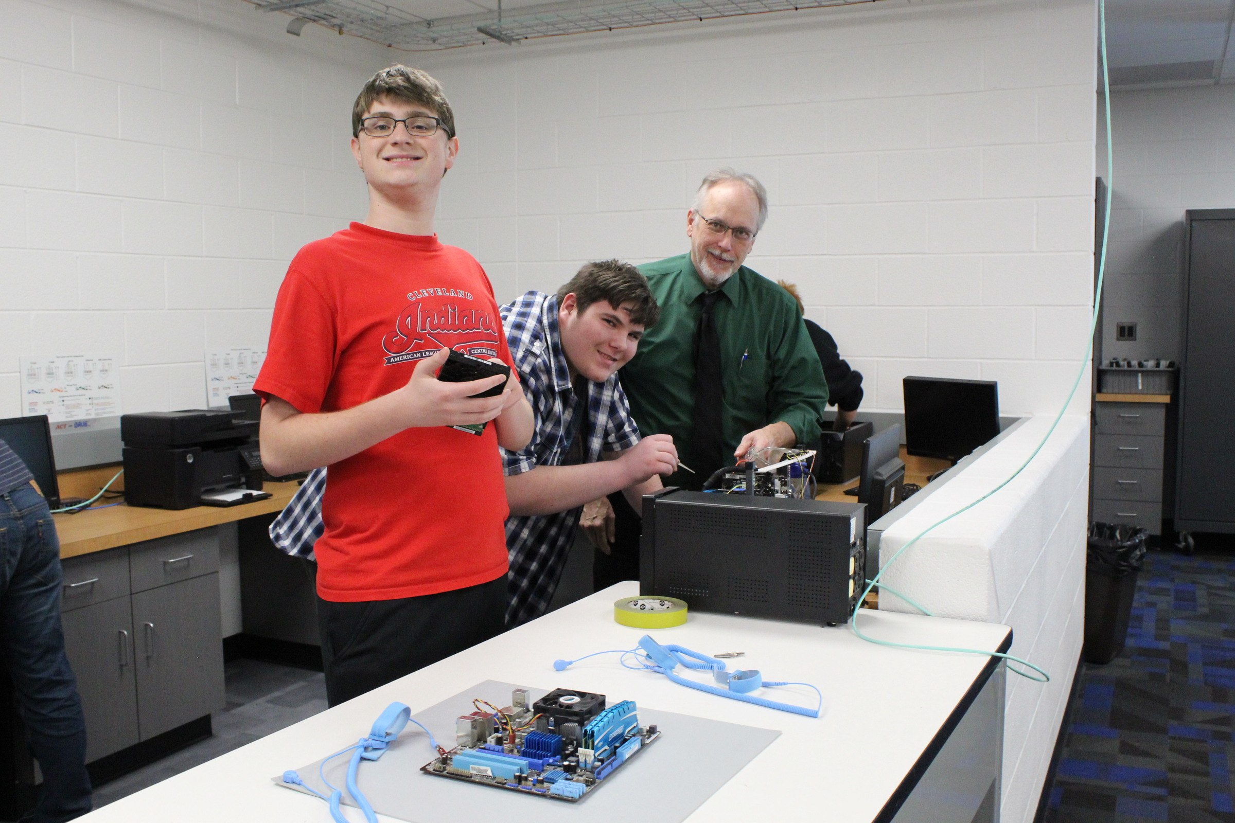 Instructor Mr Johnson in the IT lab with students
