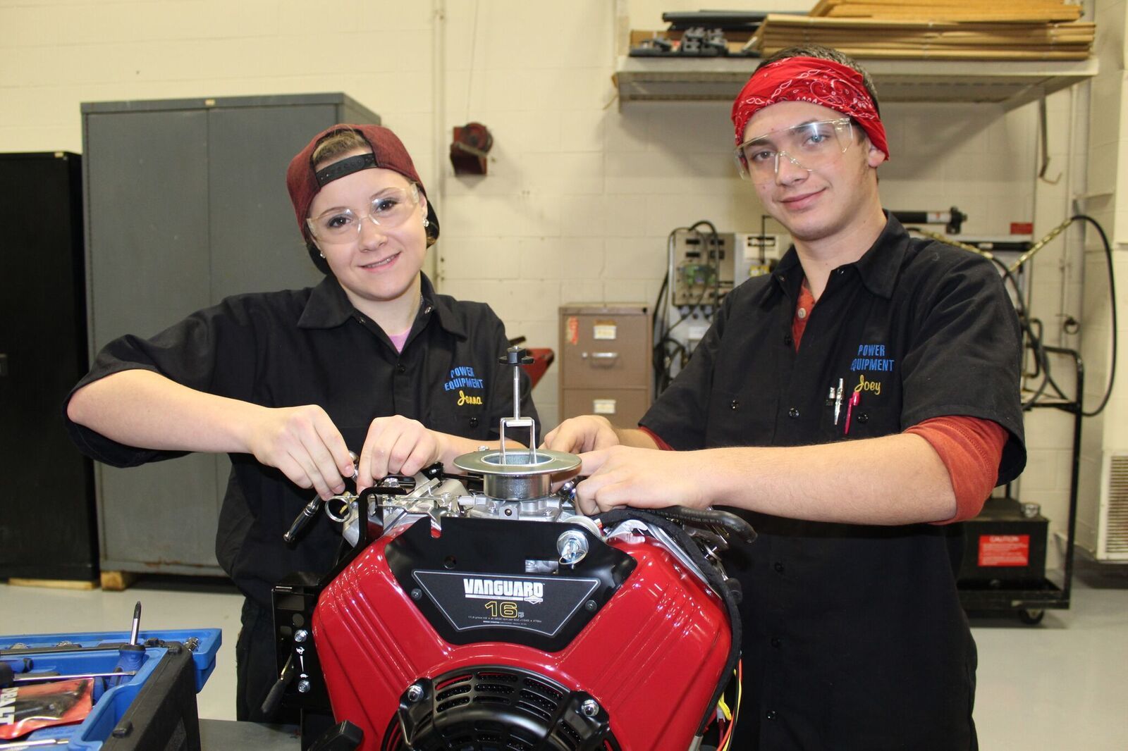 PEM students work on engine