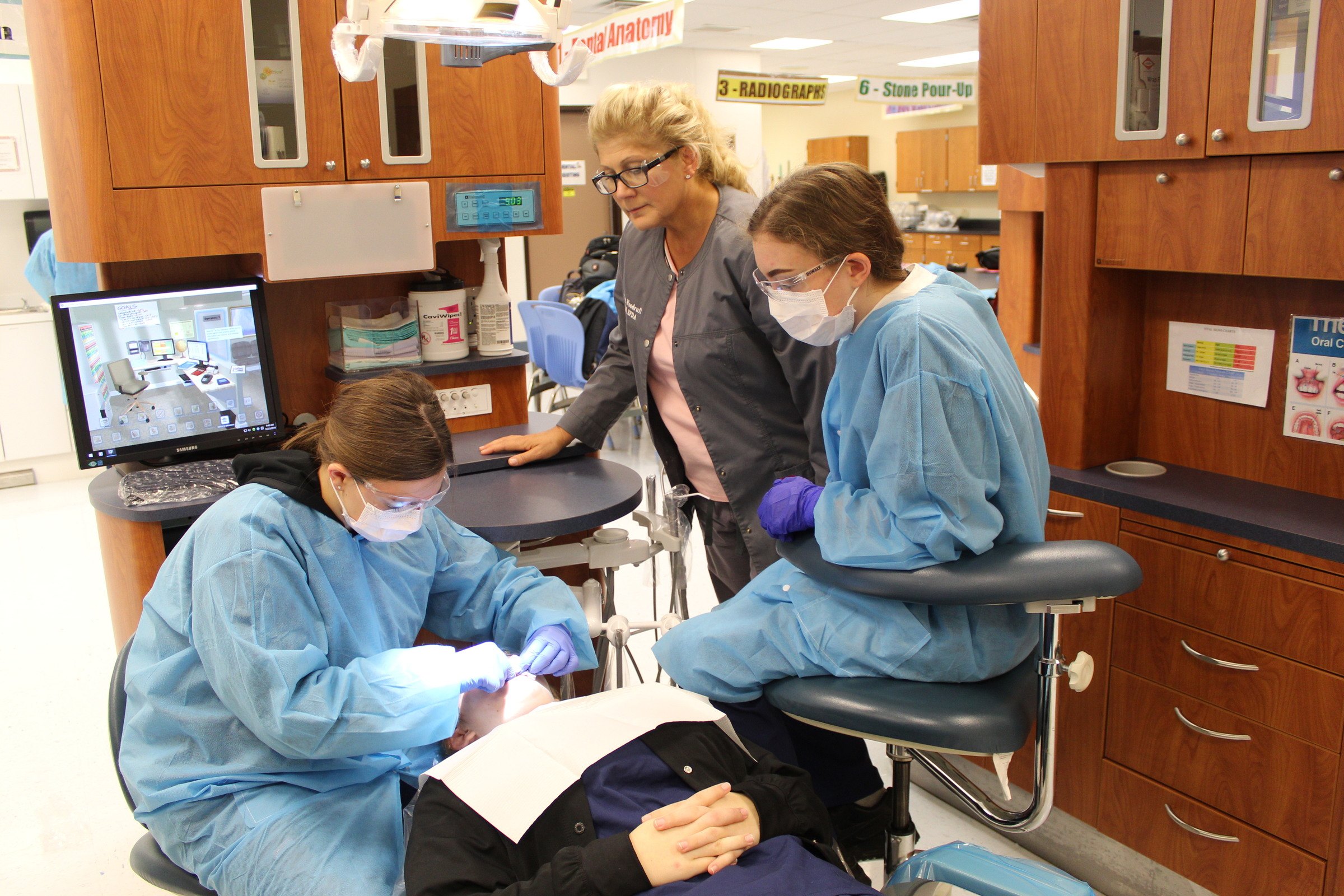 Instructor Nancy Woodruff observes students in the operatory