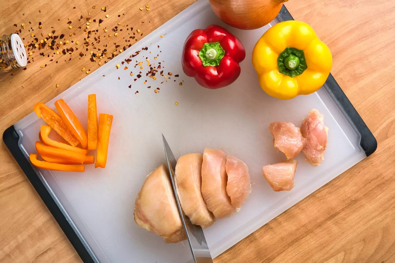 chicken being chopped by a culinary arts student