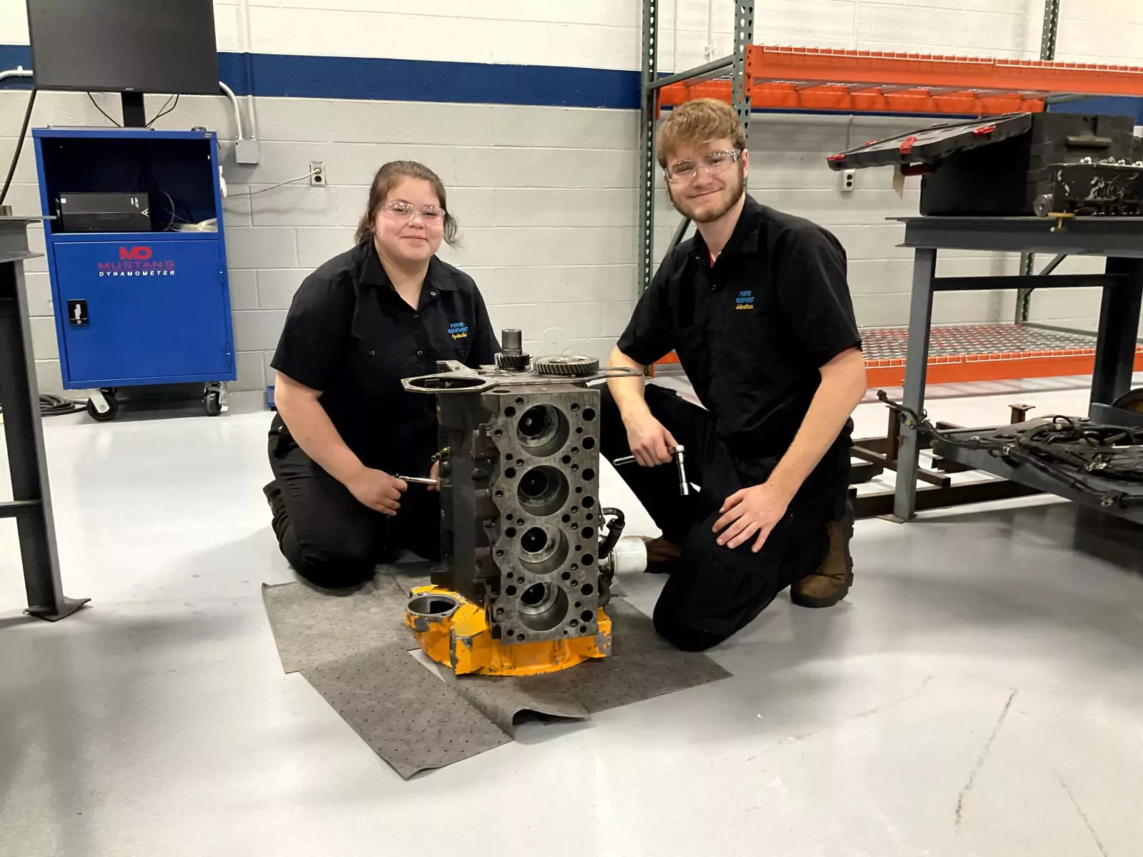 two students learning about power equipment mechanics